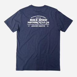 A navy-colored T-shirt with 'BIKE SHED MOTORCYCLE CO. COMMON GROUND' printed on the back.