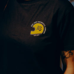 Black T-shirt with a graphic design of a  motorcycle helmet front