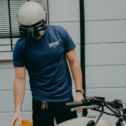 A navy-colored T-shirt with 'BIKE SHED MOTORCYCLE CO.' printed on the front