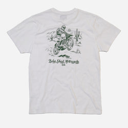 White Cream t-shirt with a graphic of a person on a motorcycle and cactus in desert with 'Bike Shed Motorcycle Co.' text, on a white background.