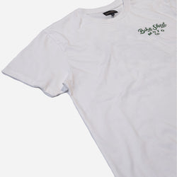 White t-shirt with dark green Bike Shed Moto Co text logo on a white background