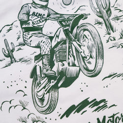 Illustration of a person riding a motorcycle in a desert landscape with cacti. Graphic screen print Bike Shed Moto Co t-shirt