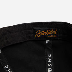Black and beige Baseball Hat with Bike Shed Moto Co. logo on a white background inside detail