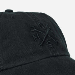 A black, unstructured baseball cap with an embroidered Bike Shed Moto Co. logo on the front detail