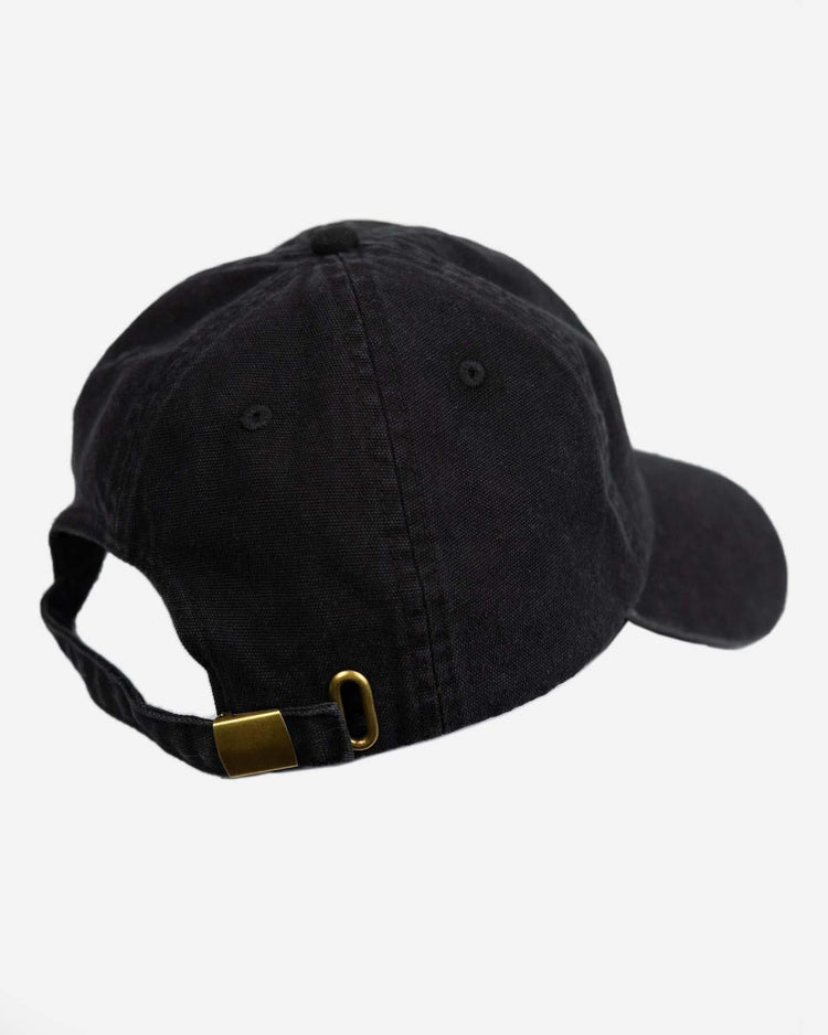 A black, unstructured baseball cap with an embroidered Bike Shed Moto Co. logo