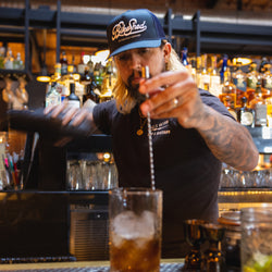 Bar staff wearing our BSMC Motorcycle Garage Baseball Hat - Navy/White