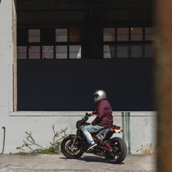 Dan sitting on his Indian Bike while wearing our BSMC Company Coach Motorcycle Jacket - Burgundy
