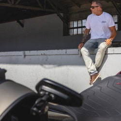 Dan sitting in the shade while wearing our BSMC Motorcycle Garage T Shirt - White & Black