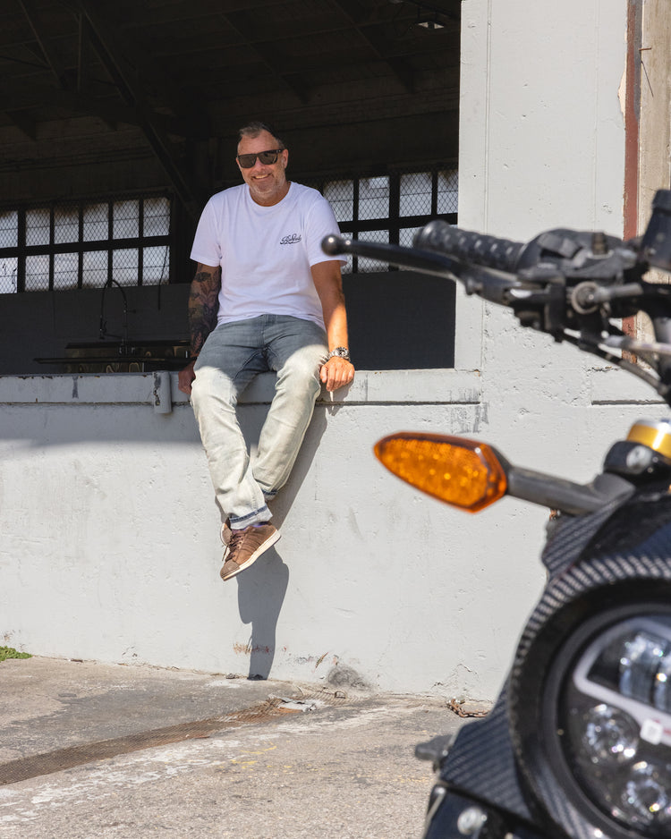 Dan smiling at the camera while wearing our BSMC Motorcycle Garage T Shirt - White & Black