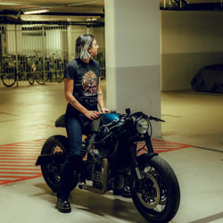 Model sitting on Honda CX500 wearing our BSMC Women's Speed Demon Graphic T-Shirt - Washed Black