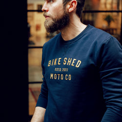 Alen posing, wearing our BSMC Moto Co. logo Sweatshirt - Navy/Mustard