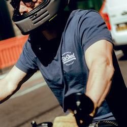 Steve wearing our BSMC Company T-Shirt - Navy while riding through traffic