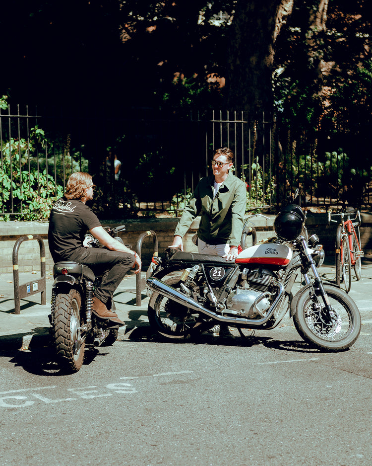 Harry wearing our BSMC Motorcycle Garage T Shirt - Black & Gold while chatting to Joe
