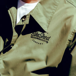 Close up shot of Joe wearing our BSMC Company Coach Jacket - Khaki Green
