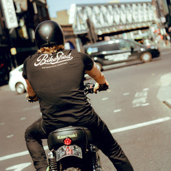 Harry on his bike at the lights wearing our BSMC Motorcycle Garage T Shirt - Black & Gold