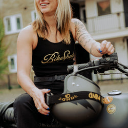 Model sitting on her bike wearing our Women's Motorcycle Garage Ribbed Tank Top - Black