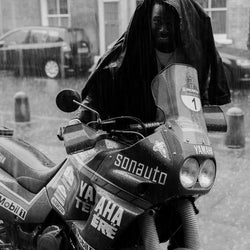 Model using our BSMC Company Coach Motorcycle Jacket - Black as an umbrella