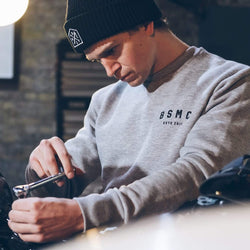 Harry working on his bike wearing our Bike Shed Motorcycle Logo Sweatshirt - Grey Marl