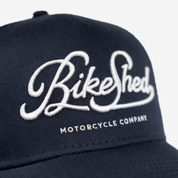 BSMC Motorcycle Garage Baseball Hat - Navy/White, logo close up