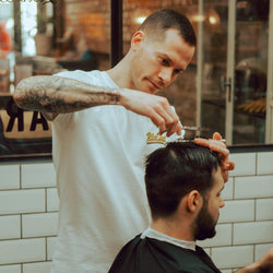 Luca wearing our BSMC Motorcycle Mural Graphic T Shirt - White cutting hair