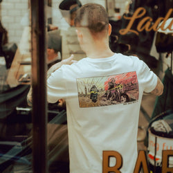Luca wearing our BSMC Motorcycle Mural Graphic T Shirt - White while cutting hair