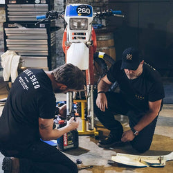 Dan working on his bike wearing our Motorcycle embroidered logo baseball hat - Black & Gold
