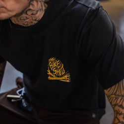 Model wearing our BSMC Speed Demon Graphic T-Shirt - Washed Black, logo close up
