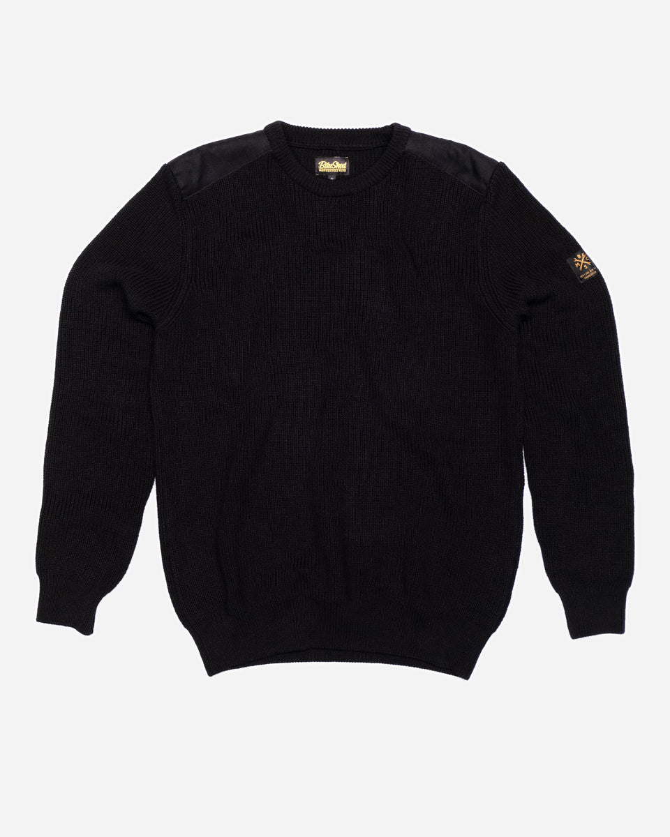 A black knit crew neck sweater with the Bike Shed Moto Co. brand label visible on the lower left side.
