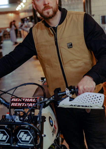 A tan Alpinestars Tech-Air 3 canvas airbag vest with a front zipper and logo on the chest.