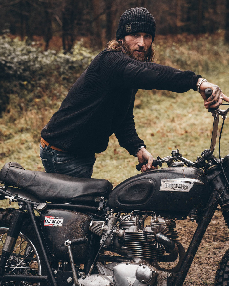 A black knit crew neck sweater with the Bike Shed Moto Co. brand label visible on the lower left side.