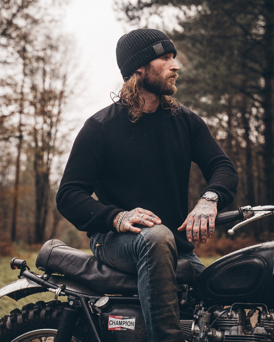 A black knit crew neck sweater with the Bike Shed Moto Co. brand label visible on the lower left side.