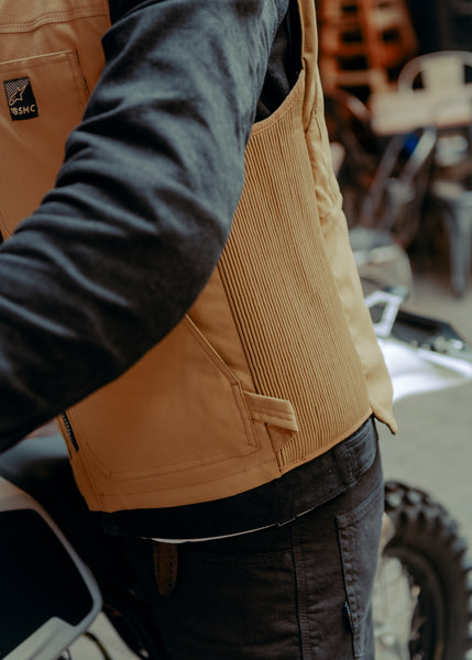 A tan Alpinestars Tech-Air 3 canvas airbag vest with a front zipper and logo on the chest.