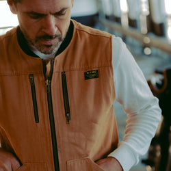 Sam wearing our BSMC Utility Vest - Tan