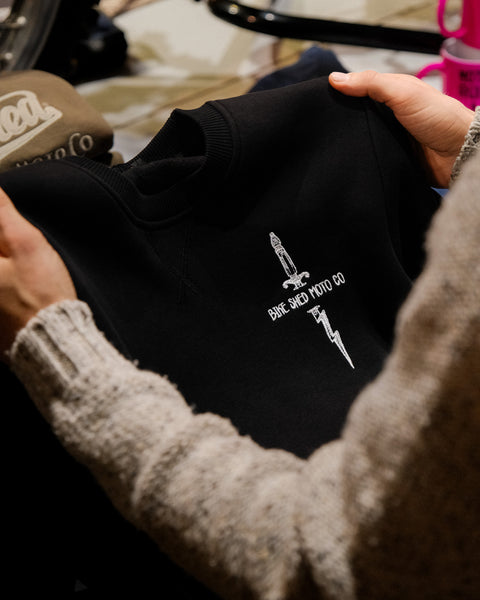Zeus Embroidered Sweatshirt Black in store close up of chest logo
