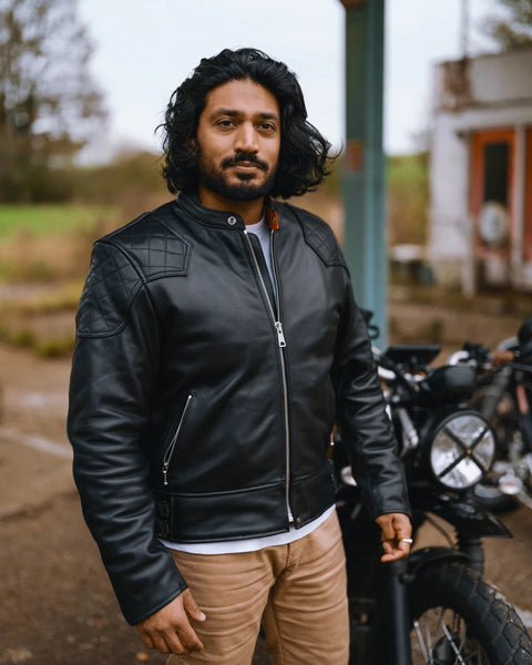 Goldtop '76 Cafe Racer Jacket - Black worn by model standing next to a motorcycle