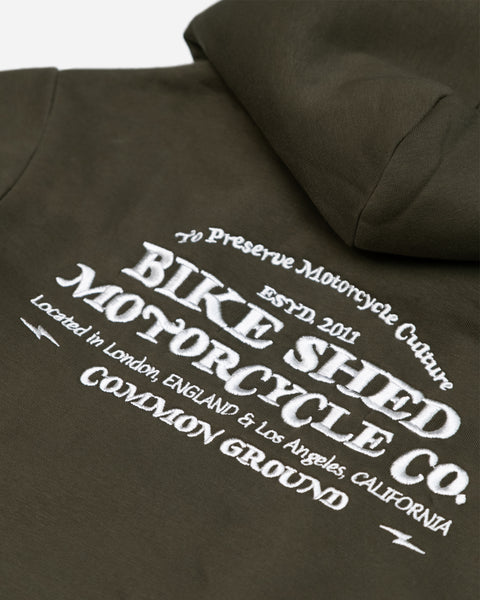 Green hoodie with 'Bike Shed Motorcycle Co.' embroidered on the back detail