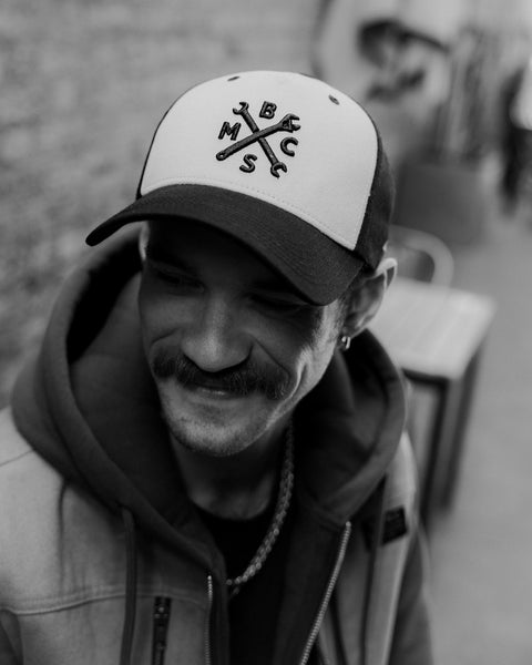 Black and beige Baseball Hat with Bike Shed Moto Co. logo on a white background front