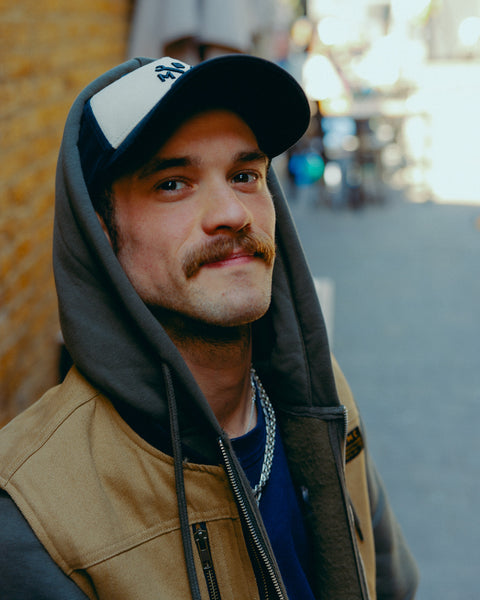 Black and beige Baseball Hat with Bike Shed Moto Co. logo on a white background front