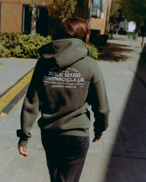 Green hoodie with 'Bike Shed Motorcycle Co.' embroidered on the back