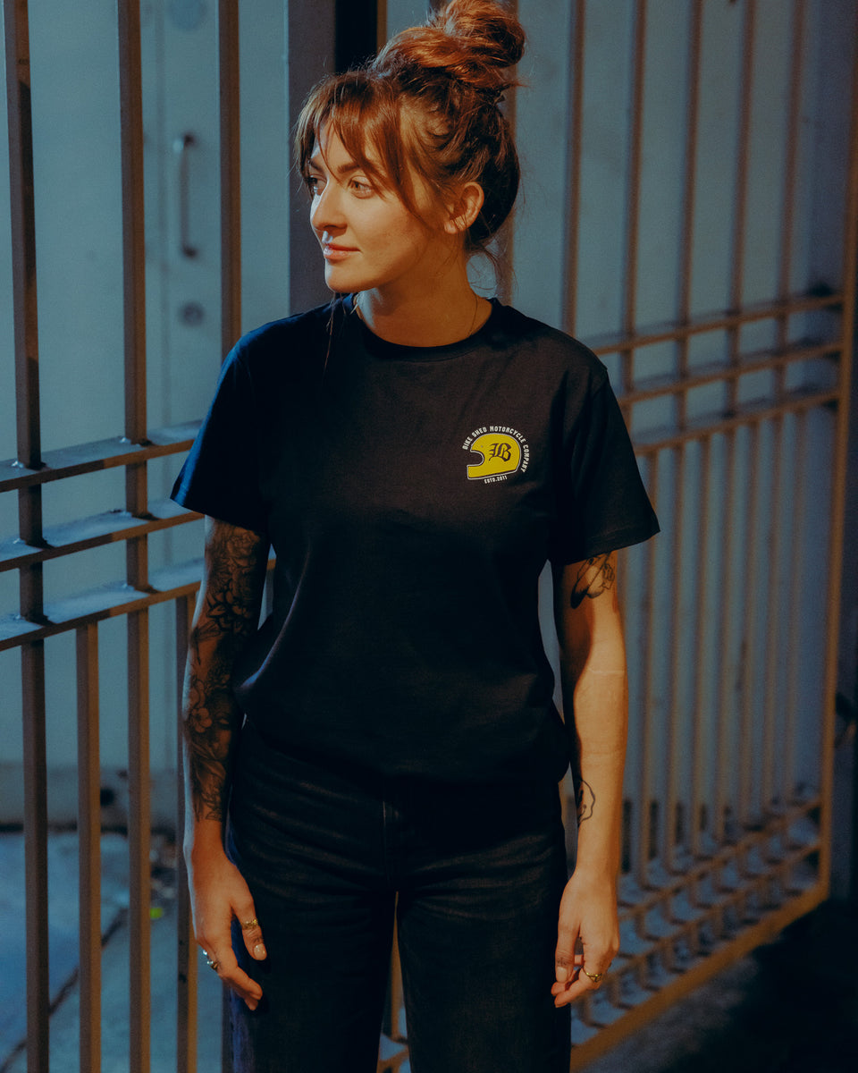 Black T-shirt with a graphic design of a  motorcycle helmet front