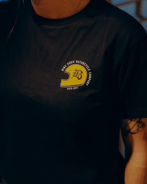 Black T-shirt with a graphic design of a  motorcycle helmet front