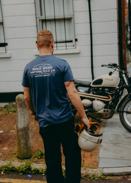 A navy-colored T-shirt with 'BIKE SHED MOTORCYCLE CO. COMMON GROUND' printed on the back.