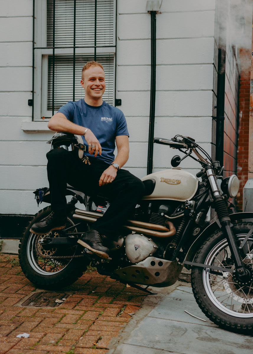 A navy-colored T-shirt with 'BIKE SHED MOTORCYCLE CO.' printed on the front.