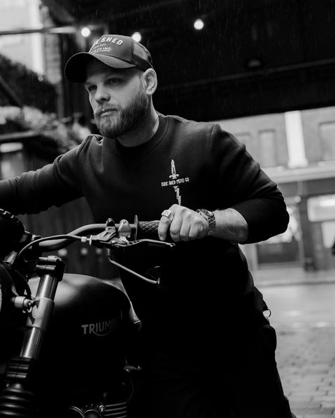 Jimbo wearing Zeus Embroidered Sweatshirt Black in the rain