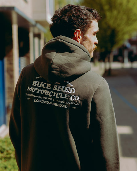 Green hoodie with 'Bike Shed Motorcycle Co.' embroidered on the back