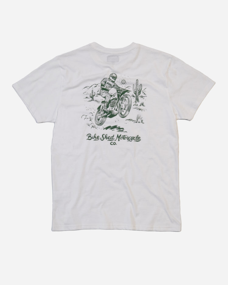 White Cream t-shirt with a graphic of a person on a motorcycle and cactus in desert with 'Bike Shed Motorcycle Co.' text, on a white background.