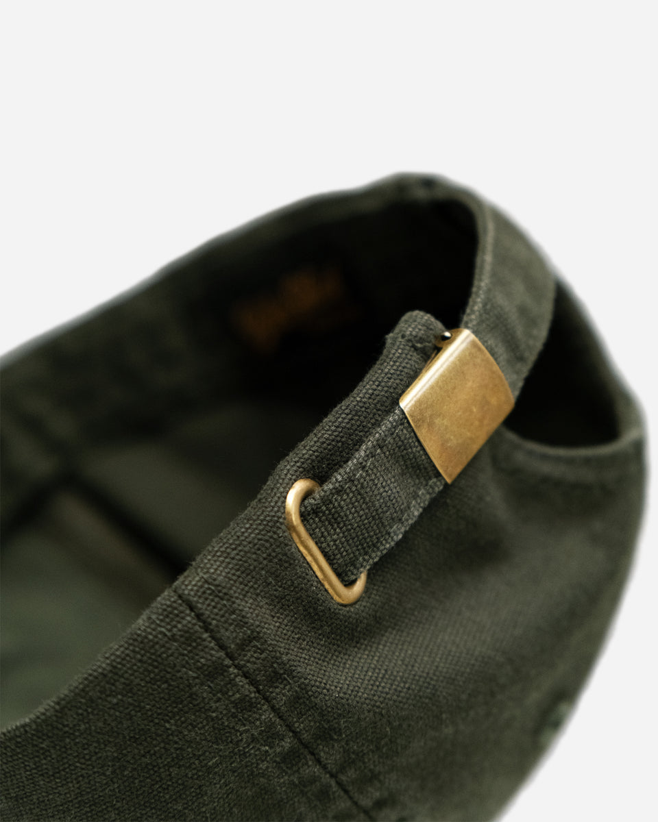 Green cap studio shot with 'Bike Shed Moto Company' logo on a white background