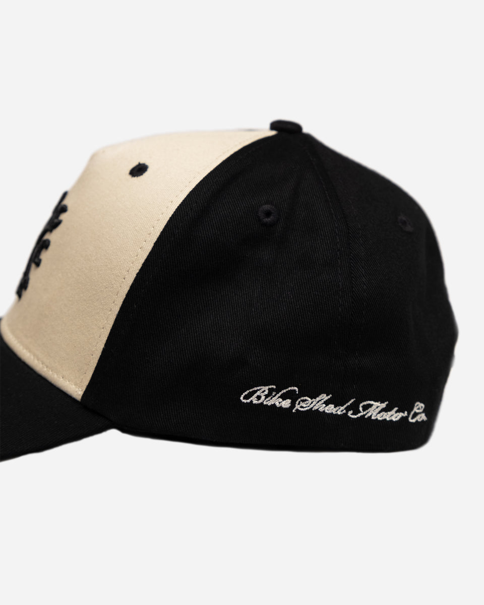 Black and beige Baseball Hat with Bike Shed Moto Co. logo on a white background side