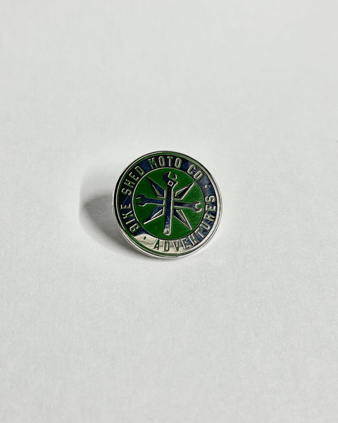 Green and silver enameled Bike Shed Moto Co Logo Adventures Pin