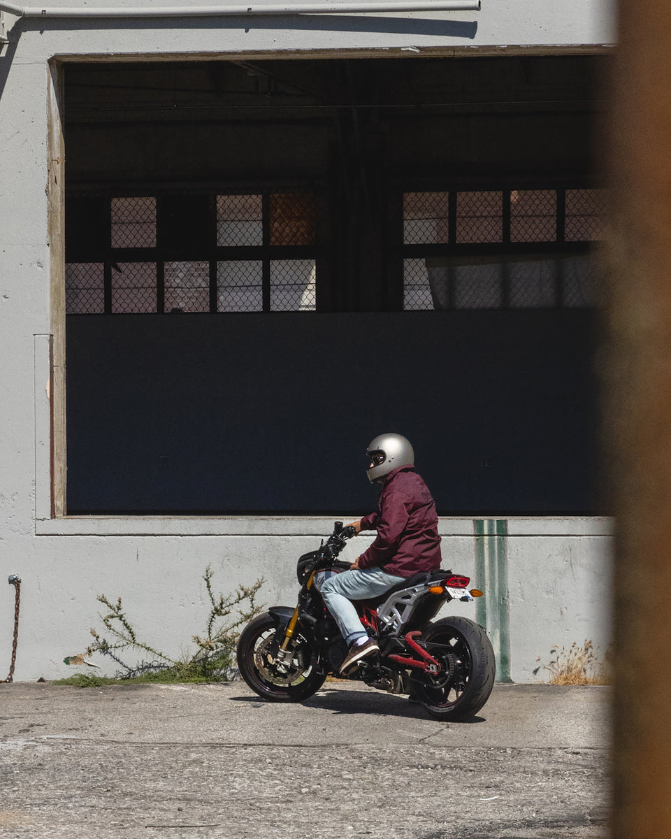 Dan sitting on his Indian Bike while wearing our BSMC Company Coach Motorcycle Jacket - Burgundy 
